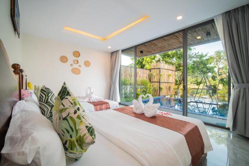 En eller flere senge i et værelse på Ban Ban Resort TeukChhou