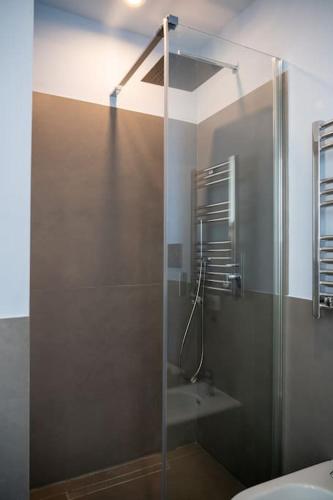 a bathroom with a glass shower with a toilet at Villa Roccia Di Mare in Capri