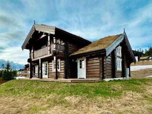 an old log house with a grass roof at Newer lovely cabin in Birkebeinerbakken Sjusjøen in Ringsaker
