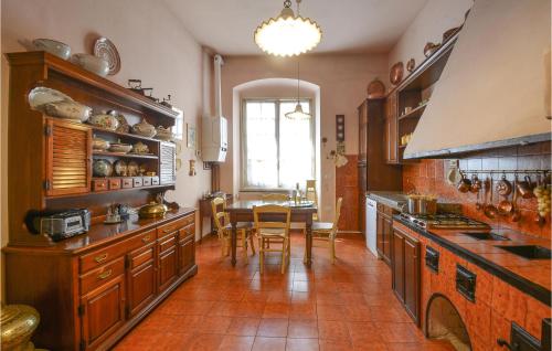 a kitchen with a table and a dining room at Gorgeous Apartment In Genova Sestri Ponente Wit,,, in Genoa
