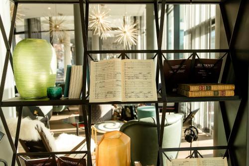 a shelf with a book and other items in a store at Motel One Bonn-Beethoven in Bonn
