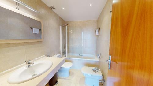 a bathroom with a sink and a toilet and a shower at Casa Raquel in L'Ampolla