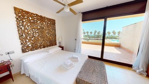 a bedroom with a bed and a large window at Casa Raquel in L'Ampolla
