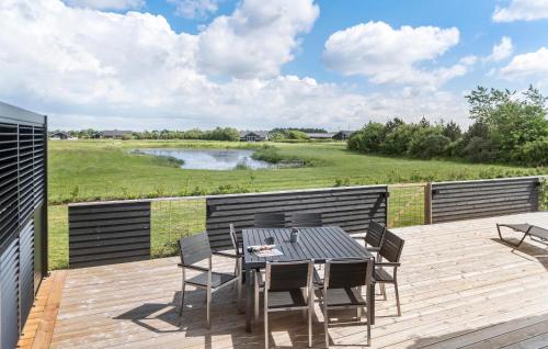 a patio with a table and chairs on a deck at Amazing Home In Tarm With Kitchen in Tarm