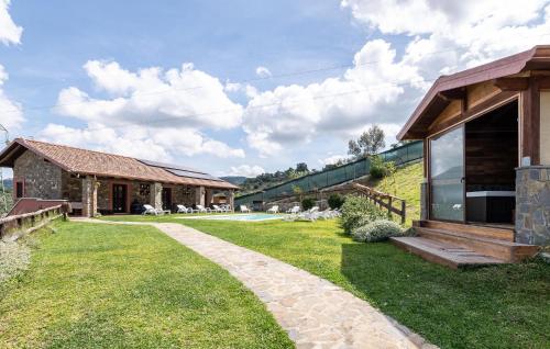 a house with a grass yard next to a building at Pet Friendly Home In Torchiara in Torchiara