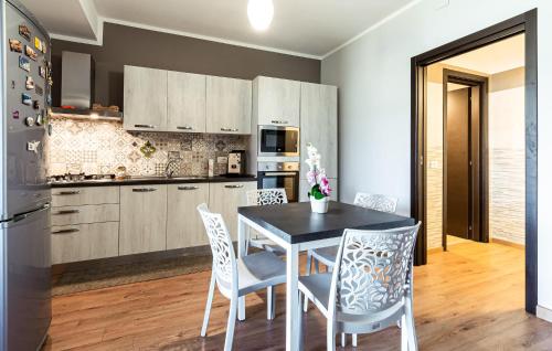 a kitchen with a dining room table and chairs at Pet Friendly Home In Torchiara in Torchiara