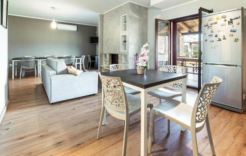 a kitchen and living room with a table and chairs at Pet Friendly Home In Torchiara in Torchiara