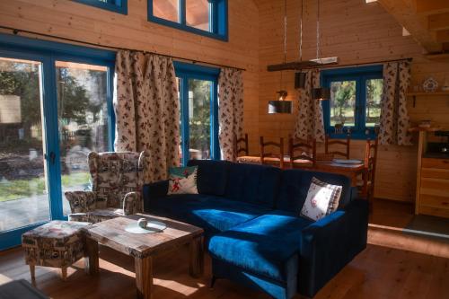 a living room with a blue couch and a table at Chalets Buky in Tatranská Lomnica