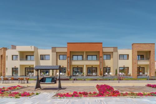 a large building with flowers in front of it at Helnan Hotel - Port Fouad in Port Said
