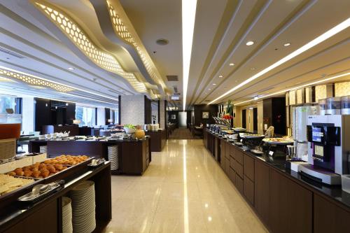 a buffet line in a restaurant with food on display at Urban Hotel33 in Kaohsiung