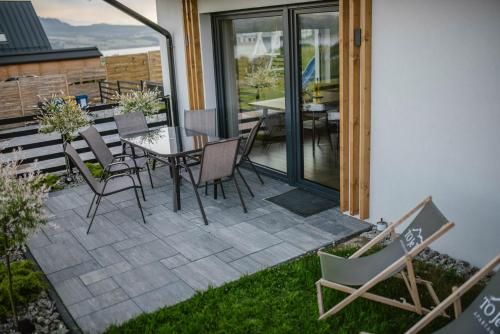 a patio with a table and chairs on a patio at To Je To apartamenty in Maniowy