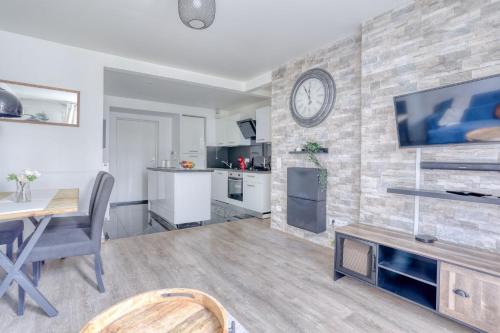 a living room with a dining table and a tv at EDEN Home in Bezons
