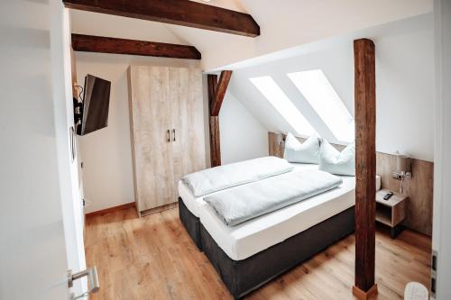 a bedroom with a bed and a skylight at Boardinghouse Victory in Augsburg