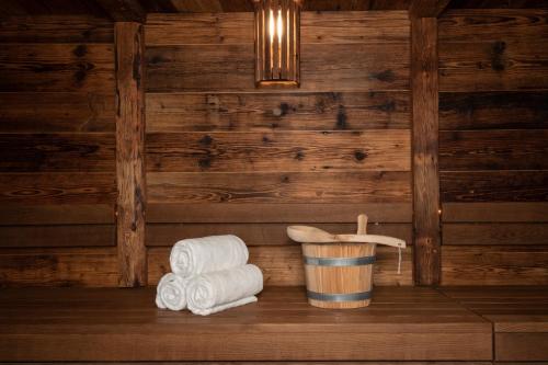 a stack of towels and a bucket of toilet paper at Titlis Resort in Engelberg