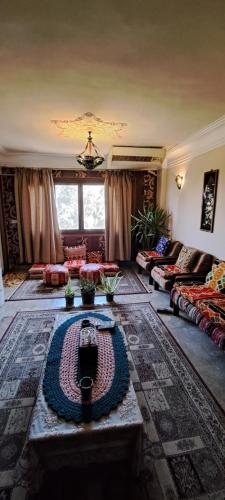 a living room with a couch and a table at Panorama apartment with a charming view of Cairo International Airport All the apt for you with free airport pick up or drop off limousine شقة بانوراما بإطلالة ساحرة على مطار القاهرة الدولي in Cairo