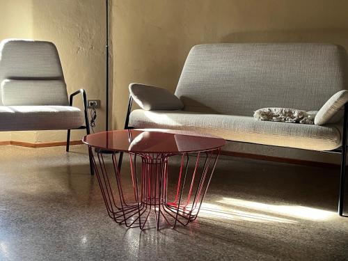 a living room with a couch and a red coffee table at B&B lo scudaio Palazzo Marchionneschi in Montescudaio