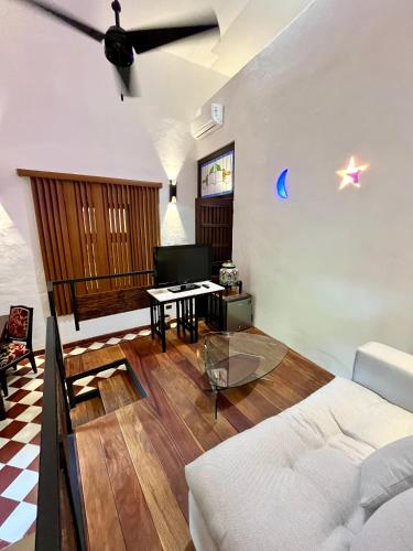 a living room with a white couch and a table at VILLA MERIDA BOUTIQUE HOTEL - Adults Only in Mérida