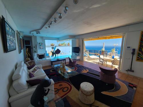 a living room with a view of the ocean at Eze sur mer - vue Saint Jean Cap Ferrat in Èze