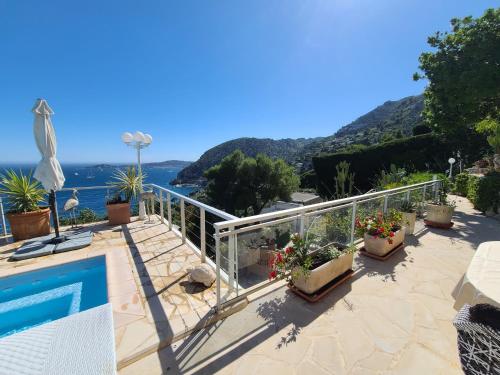 a balcony with plants and a view of the ocean at Eze sur mer - vue Saint Jean Cap Ferrat in Èze