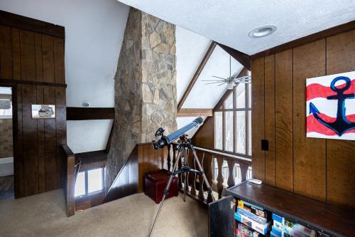 a camera on a tripod in a room with a window at 5br, 9 Beds Sleeps 14 Game Room, Pool Access in Gaylord