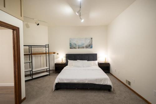 a bedroom with a bed with two night stands and two lamps at Villager Loft Pool Table & Dining Discounts in Charlevoix