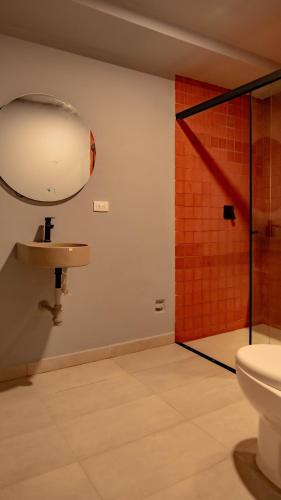 a bathroom with a sink and a shower at Leviu by Bernalo Hotels in Medellín