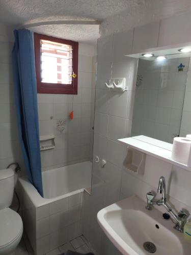 a bathroom with a toilet and a sink and a shower at victoria in Istro