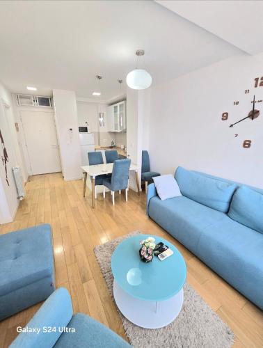 a living room with a blue couch and a table at A BLOK1 NEW BELGRADE in Novi Beograd