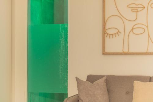 a living room with a couch and a green vase at Domus Viterbo Centro in Viterbo