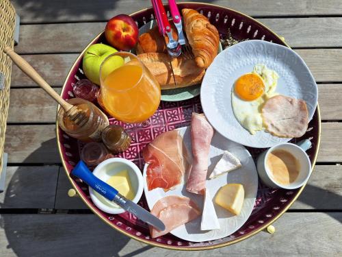 a tray of breakfast foods on a wooden table at TINY HOUSE avec piscine "La Bernadette" villa Sisyphe in Le Thoronet