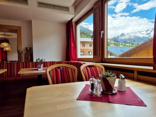 a table in a restaurant with a view of a mountain at Alpenpension Gastein in Bad Gastein