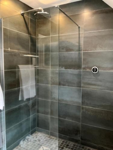 a shower with a glass door in a bathroom at Frinton45 in Frinton-on-Sea