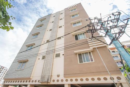 a tall building with a tower at Collection O Royal Mac in Bangalore