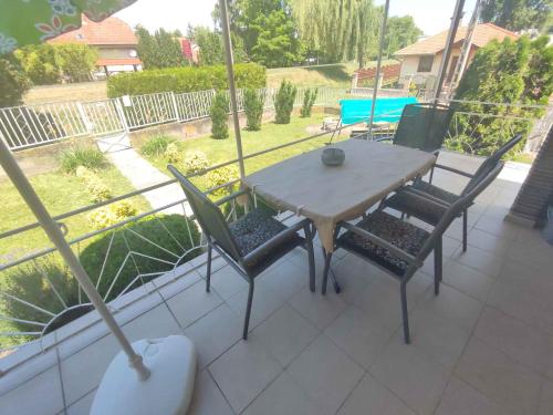 a table and chairs on a patio with a view at Holiday home in Fonyod - Balaton 18592 in Fonyód
