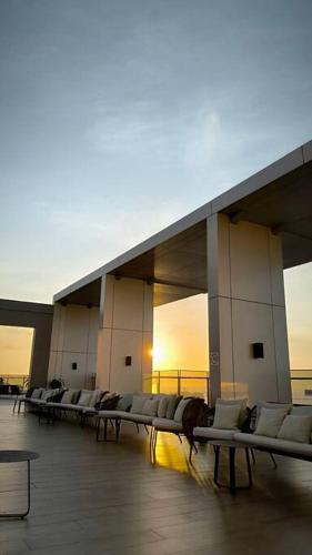a row of benches in a building with the sun setting at Lakuna 31 Sudirman in Makassar