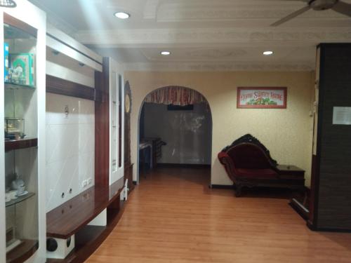 a living room with a couch and a wooden floor at AnNur Homestay in Lahad Datu