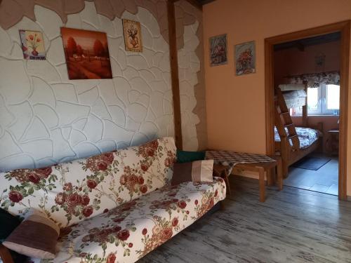 a living room with a couch and a chair at Agroturystyka POD KASZTANEM in Dobra