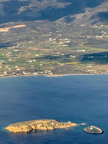 an island in the middle of a body of water at Villa Sand and Stone in Aliki