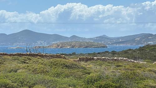 a view of a body of water with mountains at Villa Sand and Stone in Aliki
