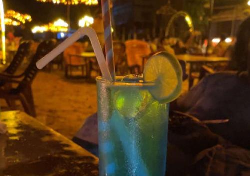 a drink with a lime and a straw on a table at Baga Vista in Baga