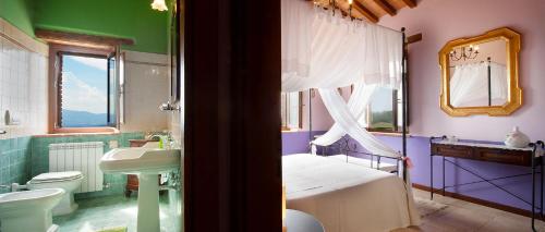 a bedroom with a bed and a sink and a toilet at Agriturismo Gattogiallo in Montegabbione