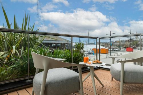 a balcony with a table and chairs on a deck at Oceania Saint Malo in Saint Malo