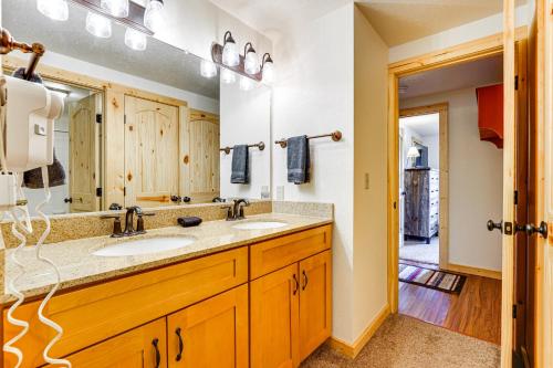 a bathroom with two sinks and a large mirror at Winter Park Condo w/ Resort Shuttle On-Site! in Winter Park