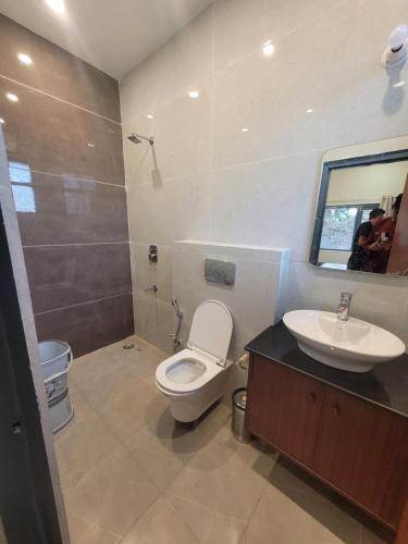 a bathroom with a toilet and a sink at 11 Gaon Homestay Lansdowne in Lansdowne