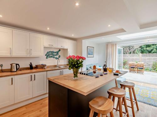 a kitchen with a counter with a vase of flowers at 2 Bed in Bembridge 94115 in Bembridge