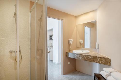 a bathroom with a sink and a shower at Sol Lunamar Palmanova Apartamentos - Adults Only in Palmanova