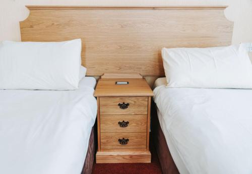 Ein Bett oder Betten in einem Zimmer der Unterkunft Welbeck Hotel & Apartments