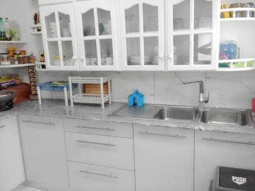 a kitchen with white cabinets and a sink at 3 bedrooms house at Grand Baie 500 m away from the beach with private pool enclosed garden and wifi in Grand-Baie