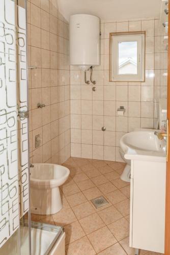a bathroom with a sink and a toilet at Apartmani Danijel in Nin