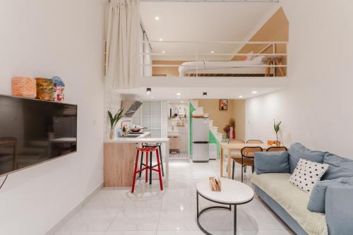 a living room with a couch and a kitchen with a bed at Shanghai Hills& XING 479 B&B in Shanghai